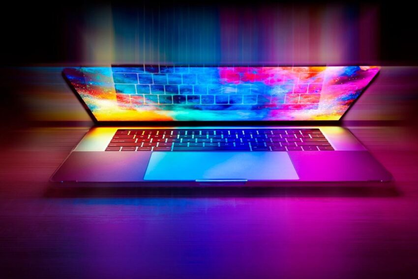 Un ordinateur portable ouvert affiche un clavier et un écran aux couleurs vives